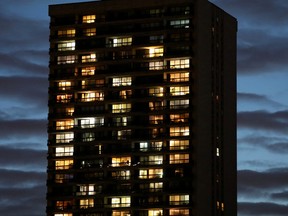 Lights shine from apartments in a residential building during the global outbreak of coronavirus disease (COVID-19) in Toronto, Ontario, on March 29, 2020.