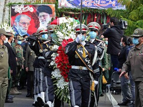 A handout picture provided by Iran's Defence Ministry on November 30, 2020 shows members of Iranian forces carrying the coffin of slain top nuclear scientist Mohsen Fakhrizadeh during his funeral ceremony in Tehran.