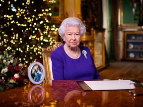 A picture released on December 24, 2020 shows Britain's Queen Elizabeth II posing for a photograph after she recorded her annual Christmas Day message, in Windsor Castle, west of London.