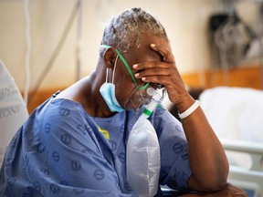 A patient with the COVID-19 breaths in oxygen in the COVID-19 ward at Khayelitsha Hospital in South Africa, on December 29, 2020.