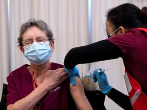 A personal support worker receives the Pfizer-BioNTech COVID-19 vaccine at the Civic Hospital in Ottawa, Ontario, Canada on Dec. 15, 2020.