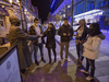 A doorman checks the identification of patrons before letting them enter a restaurant in Halifax.