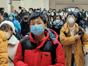 People wear face masks at Hankou Railway Station on January 22, 2020 in Wuhan, China, shortly after a new coronavirus outbreak was identified.