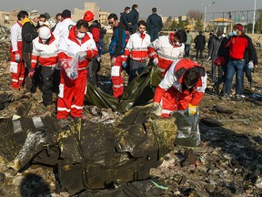 Rescue workers search the wreckage of Ukraine International Airlines Flight PS752, which was shot down shortly after takeoff from Tehran, near Shahedshahr, Iran, on Jan. 8, 2020.