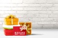 Pile of colorful gift box with ribbon and Boxing Day Sale text over brick wall background