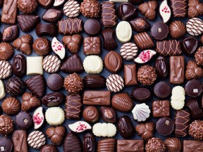 Assortment of fine chocolate candies, white, dark, and milk chocolate Sweets background Copy space Top view