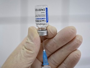 A medical worker fills a syringe with Sputnik V vaccine as she prepares to vaccinate a Russian Army service member at a clinic in the city of Rostov-On-Don, Russia, December 22, 2020.