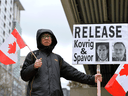 A protester holds a sign calling for the release of Michael Kovrig and Michael Spavor, outside of B.C. Supreme Court during Huawei CFO Meng Wanzhou's extradition hearing in Vancouver, January 21, 2020.