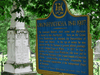 An Ontario heritage plaque honouring Oronhytekha. The plaque overlooks Orenhyateka’s family plot on the grounds of the Royal Chapel of the Mohawk at the Tyendinaga Indian Reserve near Deseronto.