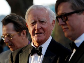British author John Le Carre, centre, poses for photographers with British actor Gary Oldman, left, and Swedish director Tomas Alfredson at the U.K. premiere of "Tinker Tailor Soldier Spy," in London, in 2011.