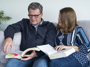 Kevin and Julia Garratt flip through the Bibles they had while jailed in China.