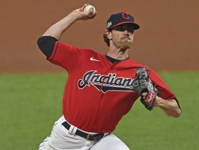 Cleveland Indians starting pitcher Shane Bieber (57) delivers in the first inning of Game 1 of an American League wild-card baseball series against the New York Yankees, Tuesday, Sept. 29, 2020, in Cleveland.