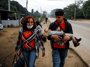 A family in Quizimistan, Honduras, take part in a caravan of migrants on Thursday, as a change to asylum rules was published that would prevent many from entering the U.S., including those threatened by gang or gender violence.