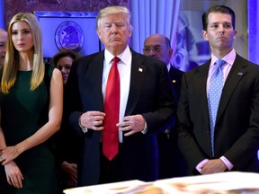 In this file photo taken on January 11, 2017, U.S. President Donald Trump stands with his children Ivanka (L) and Donald Jr., during Trump's press conference at Trump Tower in New York.