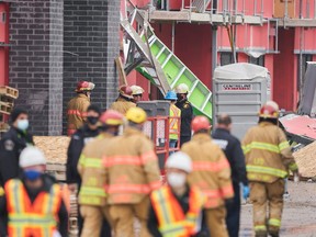 First responders survey the scene after a building under construction collapsed in London, Ont., Friday, Dec. 11, 2020.