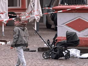 A cordoned off area with a destroyed stroller at one of the scenes where a car drove into pedestrians the center of Trier, southwestern Germany, on December 1, 2020.