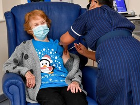 Margaret Keenan, 90, is the first patient in Britain to receive the Pfizer/BioNtech COVID-19 vaccine at University Hospital, administered by nurse May Parsons, at the start of the largest ever immunisation programme in the British history, in Coventry, Britain December 8, 2020.