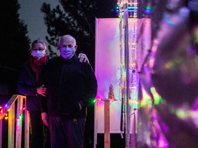 Mary Lou Baldwin and Paul Funston pose for a photo with their trailer in Fort Langley, B.C., Friday, December 18, 2020.