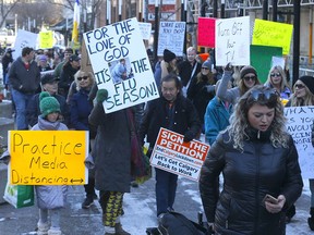 Hundreds of anti-mask protestors rally outside city hall in Calgary on Saturday, Nov. 21, 2020.