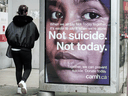 A pedestrian walks past a mental health advertisement during the COVID-19 pandemic. Canada invests just 7.2 per cent of $219 billion in total health spending on mental health.