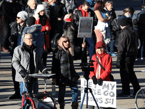 People protest Alberta's COVID-19 restrictions at Calgary City Hall on Sunday, December 20, 2020.