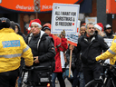 Unmasked people take part in a protest against COVID-19 restrictions in Toronto on December 20, 2020.