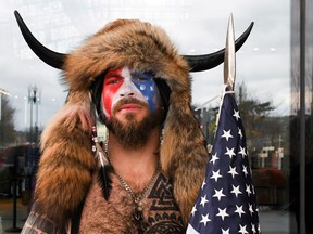 Jacob Chansley, also known as Jake Angeli, of Arizona, poses with his face painted in the colours of the U.S. flag on Capitol Hill Jan. 6, 2021.