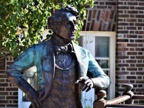 The "Holding Court" statue of Canada's first prime minister, Sir John A Macdonald, stands on Main Street in Picton, Ont.