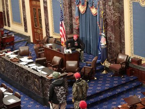 Protesters enter the Senate Chamber on January 06, 2021 in Washington, DC. Congress held a joint session today to ratify President-elect Joe Biden's 306-232 Electoral College win over President Donald Trump.