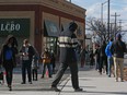 People line up outside an LCBO store in Ottawa on April 09, 2020.