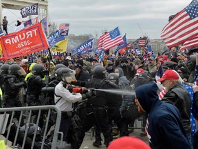 Trump supporters clash with police and security forces as they try to storm the US Capitol in Washington, DC on January 6, 2021.