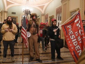 Supporters of U.S. President Donald Trump, including members of the QAnon conspiracy group, enter the U.S. Capitol in Washington, D.C., on Jan. 6.