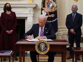 U.S. President Joe Biden signs executive orders in the White House in Washington, D.C., on Jan. 21.