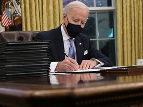 U.S. President Joe Biden prepares to sign a series of executive orders in the Oval Office just hours after his inauguration on Jan. 20, 2021 in Washington, D.C.