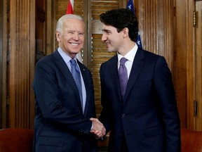 Prime Minister Justin Trudeau shakes hands with then U.S. vice-president Joe Biden in Trudeau's office on Parliament Hill on Dec. 9, 2016. The newly inaugurated president's first phone call to a foreign leader was to be to Trudeau today.