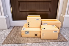 Cardboard boxes on the door mat near the entrance door