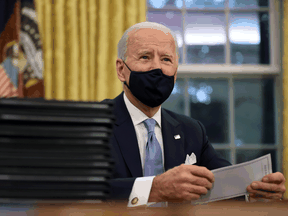 U.S. President Joe Biden prepares to sign a series of executive orders in the Oval Office just hours after his inauguration on January 20, 2021 in Washington, DC.