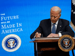 U.S. President Joe Biden signs an executive order related to American manufacturing at the White House on January 25, 2021 in Washington, DC.