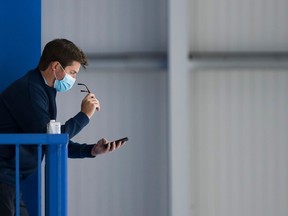 Toronto Maple Leafs general manager Kyle Dubas reads his phone during NHL training camp ahead of the NHL Stanley Cup playoffs in Toronto on Wednesday, July 15, 2020.