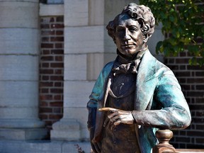 A statue of Canada's first prime minister, Sir John A. Macdonald, by sculptor Ruth Abernethy, is seen before being removed from outside a library in downtown Picton, Ont., in 2021. A 2020 poll found that a majority of Canadians opposed the removal of statues of Macdonald.