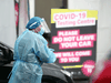 A nurse speaks to people at a COVID-19 testing facility on August 12, 2020 in Auckland, New Zealand.