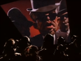 A screenshot of the music video for Genesis' "Land of Confusion."