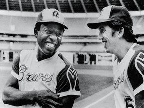 Hank Aaron (left) and Davey Johnson of the Atlanta Braves share a joke on the field before a game in Atlanta, Georgia on September 25, 1973.