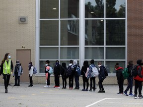 Students line up outside an elementary school in Toronto on Sept. 15, 2020.