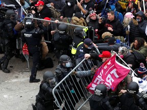 Pro-Trump protesters attempt to tear down a police barricade during a rally to contest the certification of the 2020 U.S. presidential election results by the U.S. Congress, at the U.S. Capitol Building in Washington, D.C., on Jan. 6.