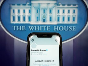 The suspended Twitter account of U.S. President Donald Trump is seen on a cellphone in the White House briefing room on Jan. 8, 2021.