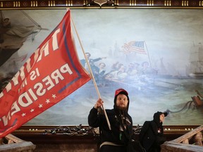 A protester holds a Trump flag inside the U.S. Capitol Building near the Senate Chamber on Jan. 6, 2021 in Washington, DC.