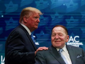 U.S. President Donald Trump greets Sheldon Adelson while taking the stage at the Israeli American Council National Summit in Hollywood, Florida, U.S., December 7, 2019.