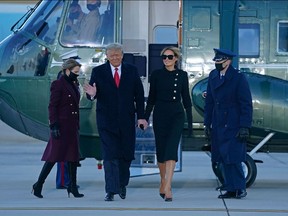 Outgoing US President Donald Trump and First Lady Melania Trump descend Marine One at Joint Base Andrews in Maryland on January 20, 2021.