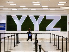 A woman walks through terminal 3, amid a spike in coronavirus disease (COVID-19) cases, at Pearson airport near Toronto, Ontario, Canada December 30, 2020.